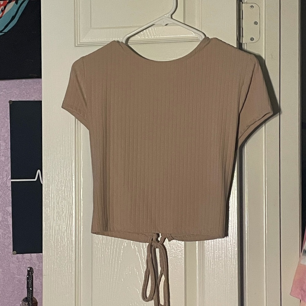 Tan cropped top with a tie up backing